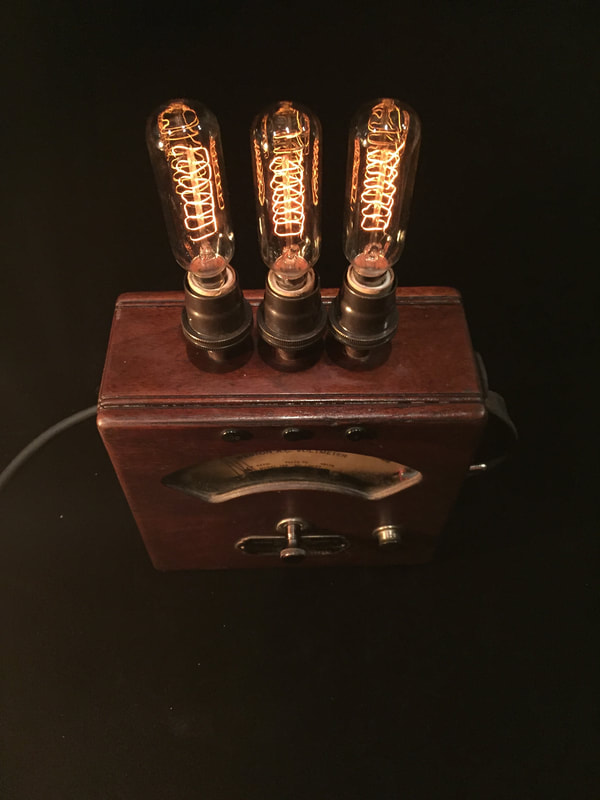 Volt meter lamp featuring Edison bulbs.  Measures current
